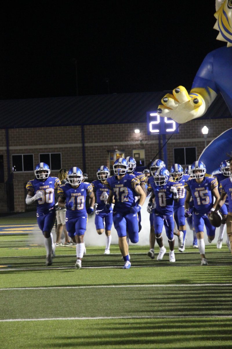 Corsicana Tigers running from the tiger after halftime.