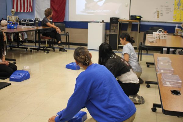 As the video is playing, they get ready to perform CPR.